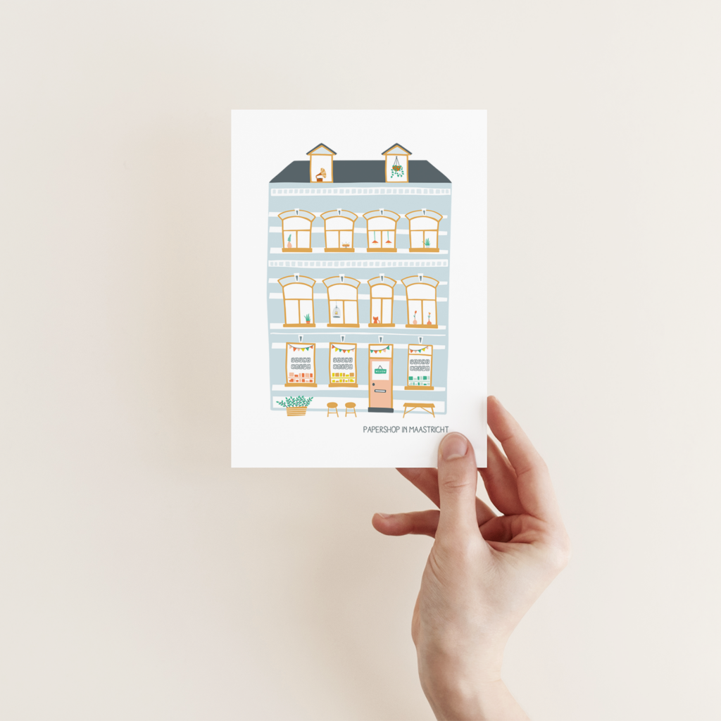 Papershop-postkaartje als cadeau bij aankoop – illustratie van de winkelgevel.